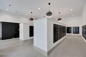 The tasting room has a wall of wine racks and a large white wall with lights